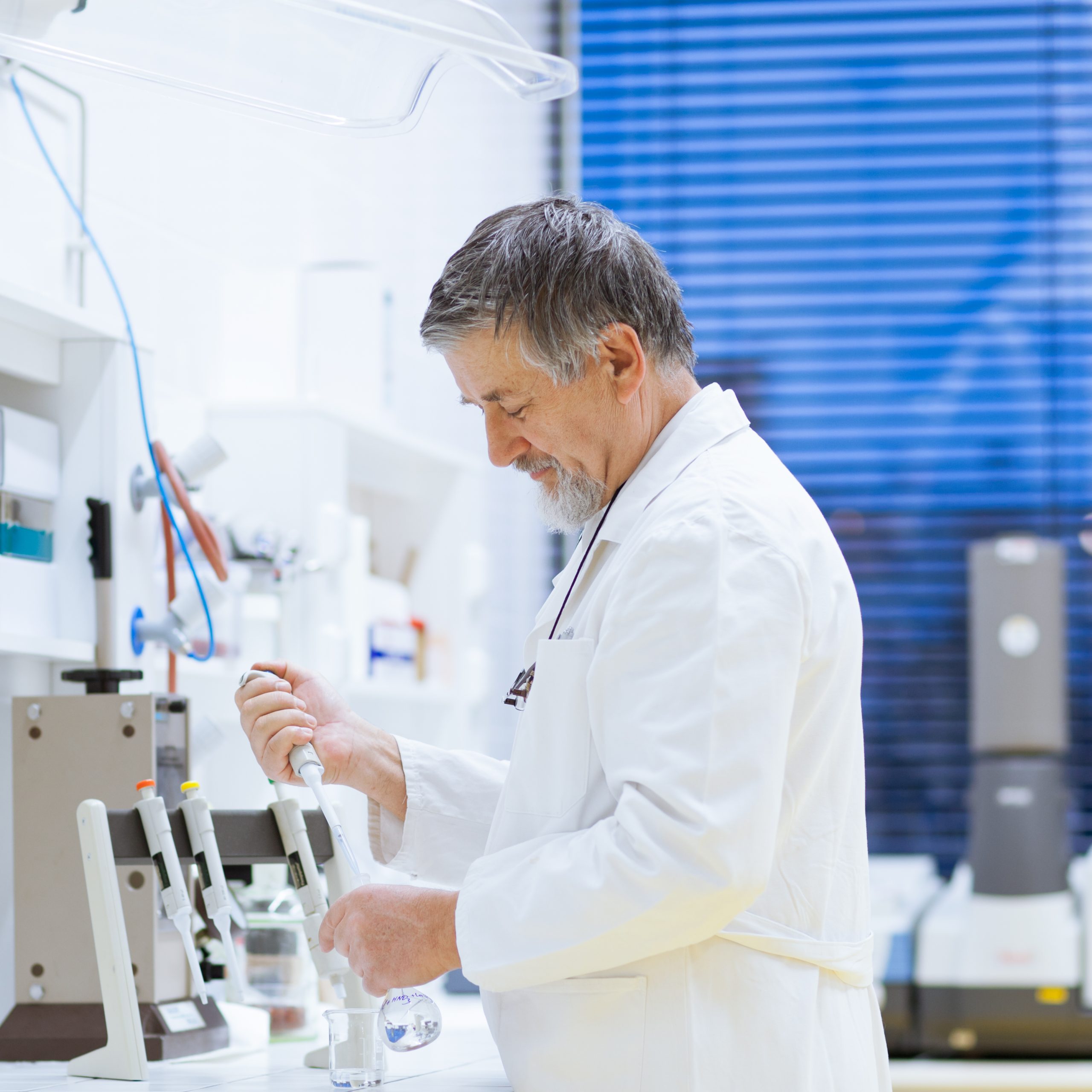 senior male researcher carrying out scientific research in a lab